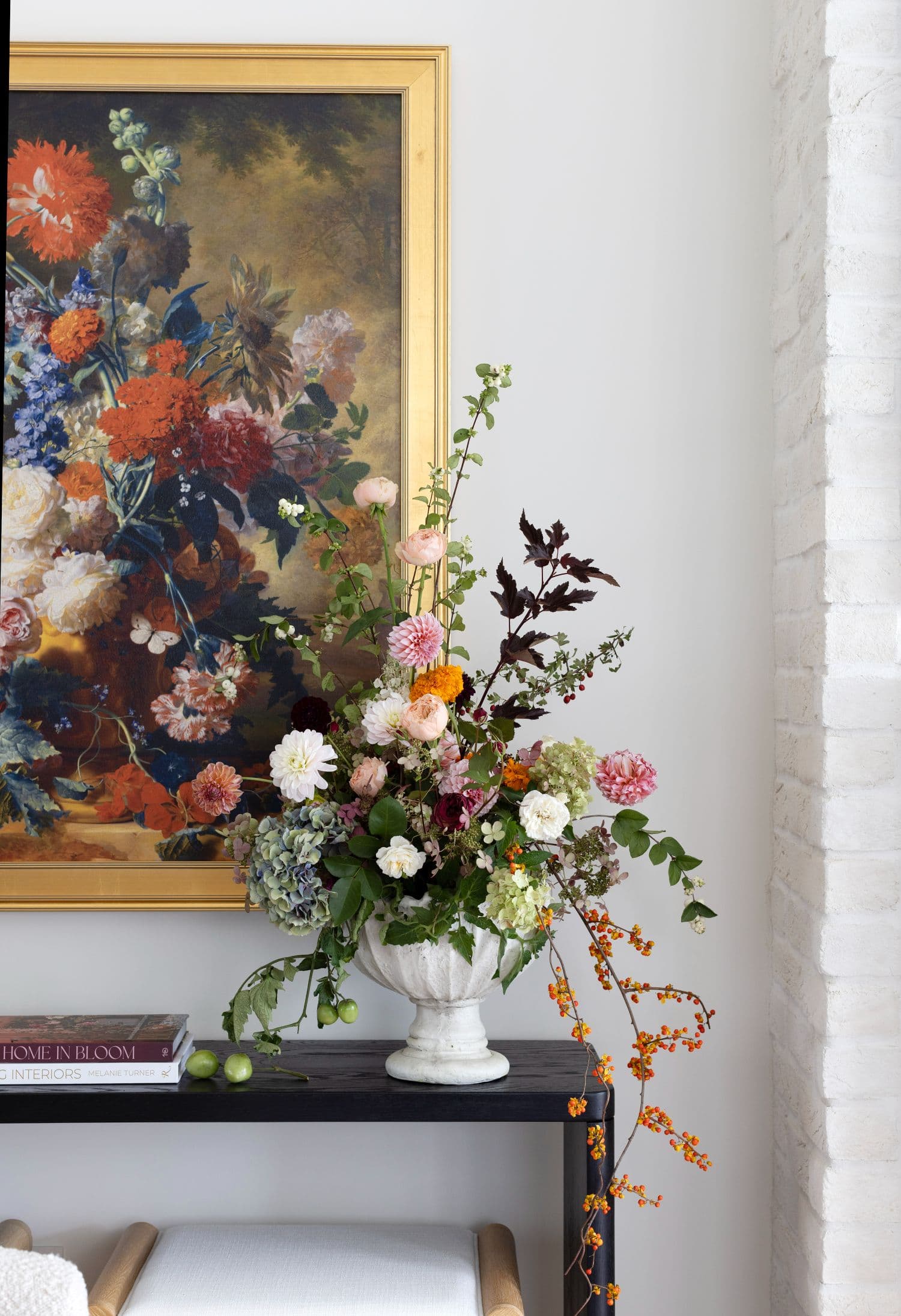 Bloomiér urn arrangement of dahlias, hydrangea, garden roses and bittersweet on a black console in a Vancouver entry